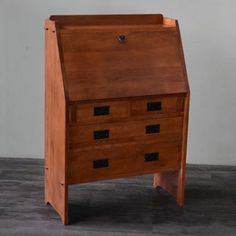 a wooden desk with two drawers on the top and one drawer open to reveal something