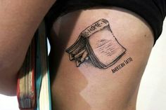 a woman's thigh with a book tattoo on her left side ribcage