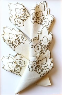 four napkins with flower designs on them