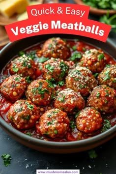 meatballs with sauce and parsley in a bowl on top of a black table