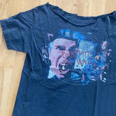 a blue t - shirt with an image of a man's face on it