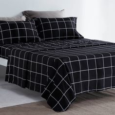 a bed with black and white checkered sheets