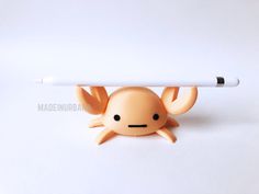 a toy with a pencil in it's mouth and an octopus on its back