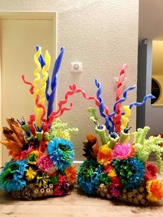 two vases filled with colorful flowers on top of a table