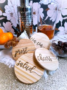 three wooden coasters with the words drink, frosting, and salt on them