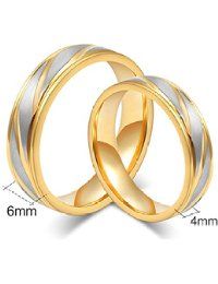 two gold and silver wedding rings with the word vox on it's side