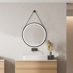 a bathroom with a sink and mirror hanging on the wall above it's counter