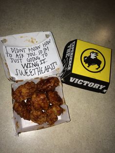 a box filled with fried food sitting on top of a counter next to a wallet