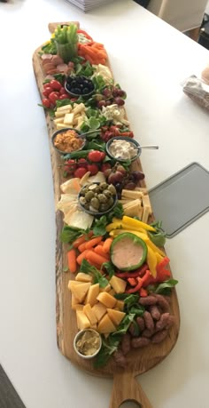 a long wooden platter filled with lots of different types of food