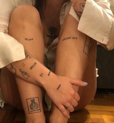 two people with matching tattoos on their legs