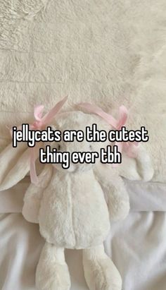 a teddy bear laying on top of a bed with the caption jellycats are the cutest thing ever tbh