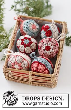 crocheted ornaments are in a basket on the table