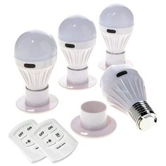 four white light bulbs sitting on top of each other next to a cup and saucer