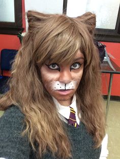 a person with long hair and cat makeup