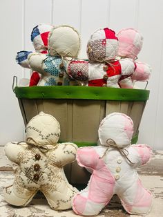 several stuffed teddy bears sitting in a basket