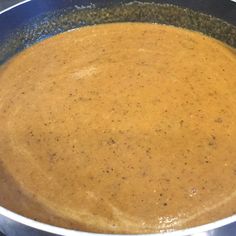 a pot filled with soup sitting on top of a stove