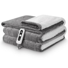 three blankets stacked on top of each other with an electric heating device plugged in