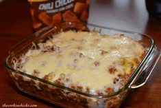 a casserole dish with cheese and meat in it next to a can of chili cheddar