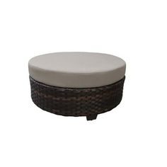 a round ottoman sitting on top of a white surface