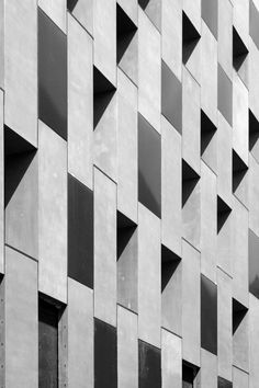 a black and white photo of the side of a building with geometric designs on it