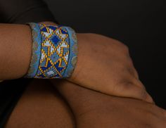 Geometric Cuff Embroidered Bracelet for Women, Textile Blue Background, Boho Bracelet, Bracelet for Women Stylish bracelet with soothing color of Blue that you can easily match with your outfit. It will surely add to your style. The bracelet is hand made needle work with 100% natural thread, all environmentally friendly material (100% cotton and brass, NO plastic) for people that we share our concern about environment with. One item takes days and days of needlework. The artistic patterns inspir Blue Wearable Art Jewelry For Festival, Blue Handmade Wearable Art Bracelets, Blue Handmade Wearable Art Bracelet, Artisan Blue Cuff Bangle Bracelet, Artisan Blue Bangle Cuff Bracelet, Artisan Handmade Blue Bangle, Traditional Adjustable Blue Bangle, Adjustable Embroidered Bangle Bracelet, Artisan Blue Bangle Bracelets