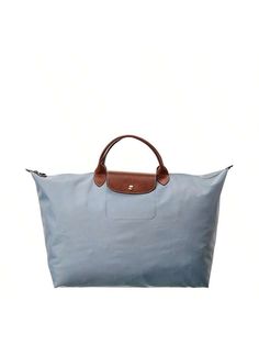 Introducing the Longchamp Le Pliage Large Canvas Top Handle Tote, a symbol of sophistican and timeless elegance. Made by the renowned brand Longchamp, known for its understated luxury leather goods with a French touch, this tote bag is the perfect accessory for women who value both style and funcnality.Crafted with steel canvas and accentuated with brown leather, this tote bag exudes a modern yet classic vibe. The gold-tone hardware adds a touch of glamour, elevating its over design. Its spauser Longchamp Le Pliage Large, Classic Vibe, Longchamp Le Pliage, Large Canvas, Leather Goods, Luggage Bags, Bags Women, Top Handle, Brown Leather