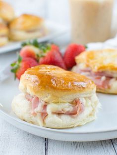 ham and cheese biscuits on a plate with strawberries