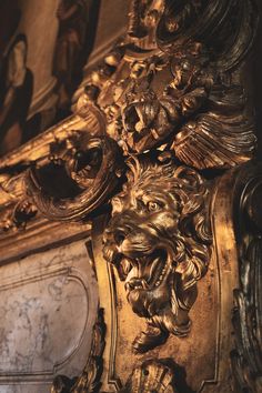 an ornate gold clock with lions on it's face