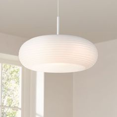 a white light hanging from the ceiling in a room