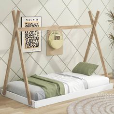 a white bed with wooden frame and green pillows on it in front of a geometric wallpaper