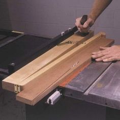 a person using a table saw to cut wood