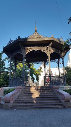 an ornate gazebo with steps leading up to it