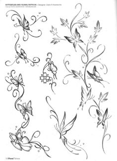 some flowers and butterflies on a white paper with black ink in the middle, as well as