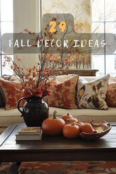 a living room filled with lots of furniture and fall decorations on top of a coffee table