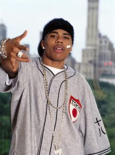 a young man wearing a baseball uniform pointing to the side with his finger in front of him