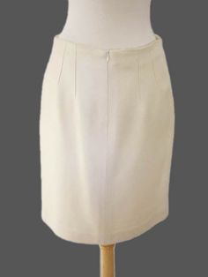 Here is a wonderful women's skirt from Kiton. As is their sartorial tradition, each Kiton garment is handmade in their factory in Naples, Italy and features the finest hand stitching throughout, and of course their exclusive fabrics are among the most luxurious in the world! DETAILS: Color: Cream Size Tagged: IT 44 Fabric: 100% Silk Weight: Spring/Summer/Fall Lining: Yes Made in: Italy MEASUREMENTS: Waist: 30" Hips across: 19" Length: 20" Elegant Full Skirt For Office, Elegant Cotton Pleated Skirt, Elegant Cotton Skirt, Fitted Office Skirt With Box Pleat, Semi-formal Full Skirt With Lining, Fitted Box Pleat Skirt For Office, Semi-formal Full Lined Skirt, Elegant Full Mini Skirt For Formal Occasions, Fitted Workwear Skirt With Box Pleat