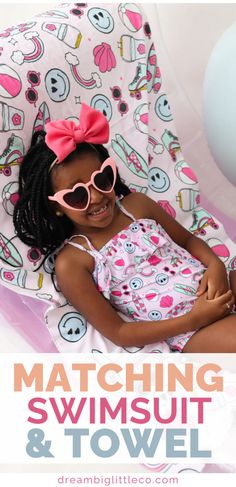 girl laying down on a beach towel that's light pink with blue smiley faces, surfboards, rainbows and hot pink sunglasses on it. She's wearing a matching one piece swimsuit in the same print and has pink heart sunglasses on. Cute Summer Swimwear For Sunbathing, Cute Swimwear For Beach Season Sunbathing, Cute Swimwear With Uv Protection For Vacation, Cute Swimwear For Sunbathing Beach Season, Cute Swimwear For Sunbathing In Beach Season, Playful Swimwear With Adjustable Straps For Summer, Adjustable Sleeveless Summer Swimwear, Adjustable Summer Tankini For Swimming, Cute Spring Beach Tankini