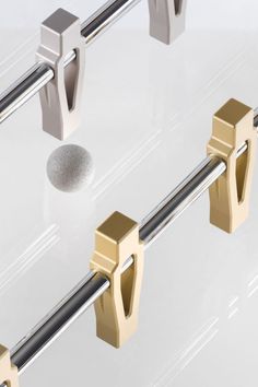 the handles and bars on this glass table are made out of brass, silver and stainless steel