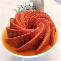 a white bowl filled with sliced fruit on top of a table