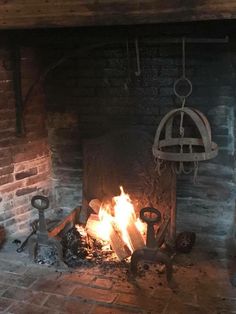 an old fireplace is lit with fire and coal