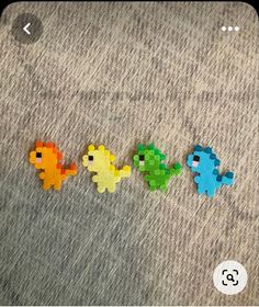 four different colored plastic toys are laying on the floor