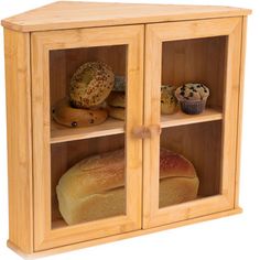 a wooden cabinet filled with bread and muffins