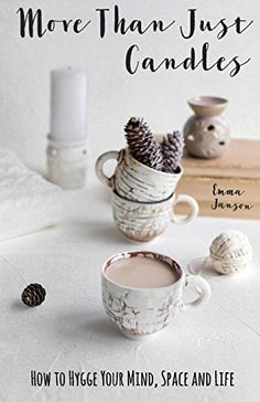 the cover of more than just candles, with two cups filled with hot chocolate and pine cones