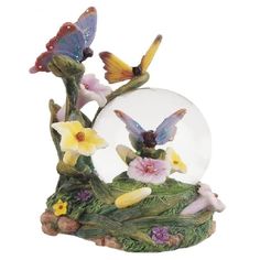 a snow globe with flowers and butterflies inside