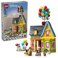 the lego disney house has balloons on it's roof and is next to an open box