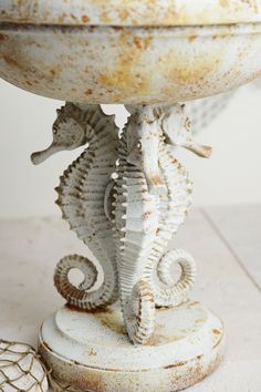 a sea horse statue sitting on top of a table