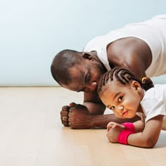 a father and daughter playing on the floor