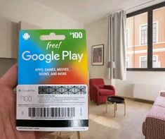 someone holding up a google play card in their living room