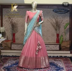 a mannequin dressed in a pink and blue lehenga