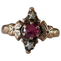 Crafted in the late nineteenth century, this antique Victorian ring is designed around an approximately 0.25-carat ruby and accompanied north and south by two seed pearls and ornately engraved flowers. Set in 10K rose gold. Historic Jewelry, Victorian Wedding Ring, Antique Jewelry Victorian, Antique Rings Victorian, Seed Pearl Ring, Victorian Ring, Engraved Flower, North And South, Victorian Rings